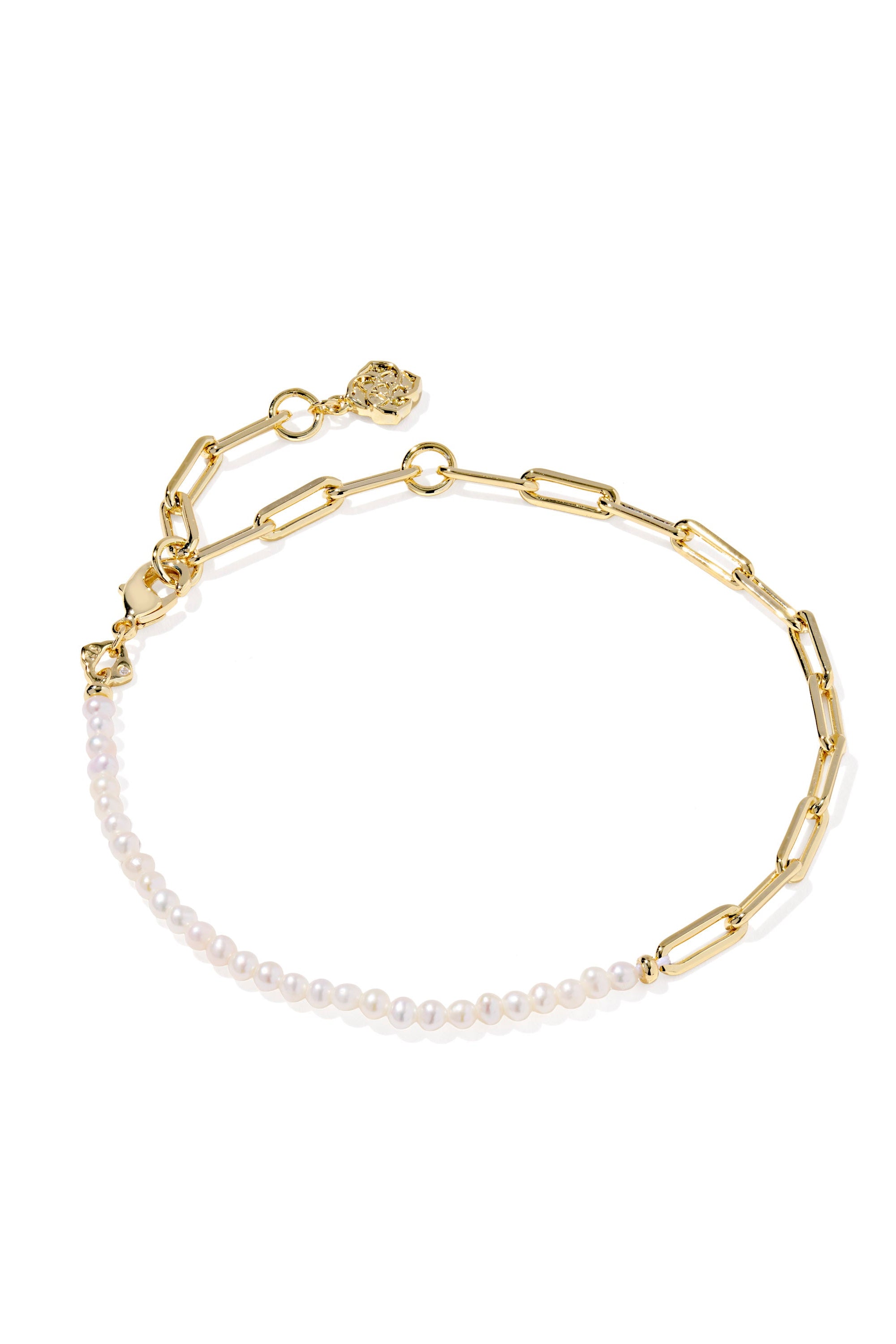 Gold chain bracelet with pearl beads on a white background